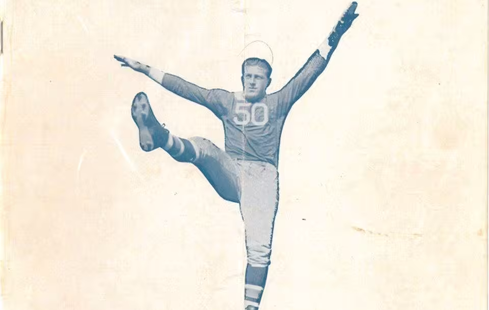Plain manilla colored program cover with blue and gray writing an an image of Giants player number 50 in a football pose.
