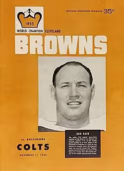 Bright orange Cleveland Browns vs Colts game day program featuring Gain on a 1956 Browns program