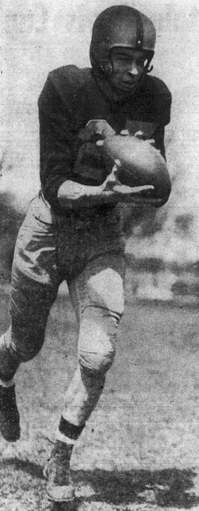 Black and white newspaper quality action shot of American football player Al Brosky, in full Illinois football uniiform returning an interception in 1951.