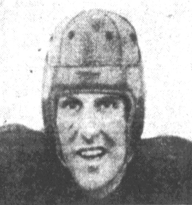 grainy black and white head shot of American football player Angelo Bertelli with his leather helmet on.