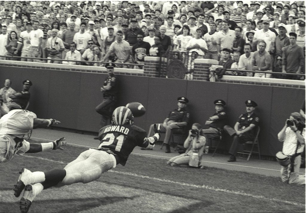 black and white game action photo of Desmond Howard “the Catch” vs Notre Dame, 1991.