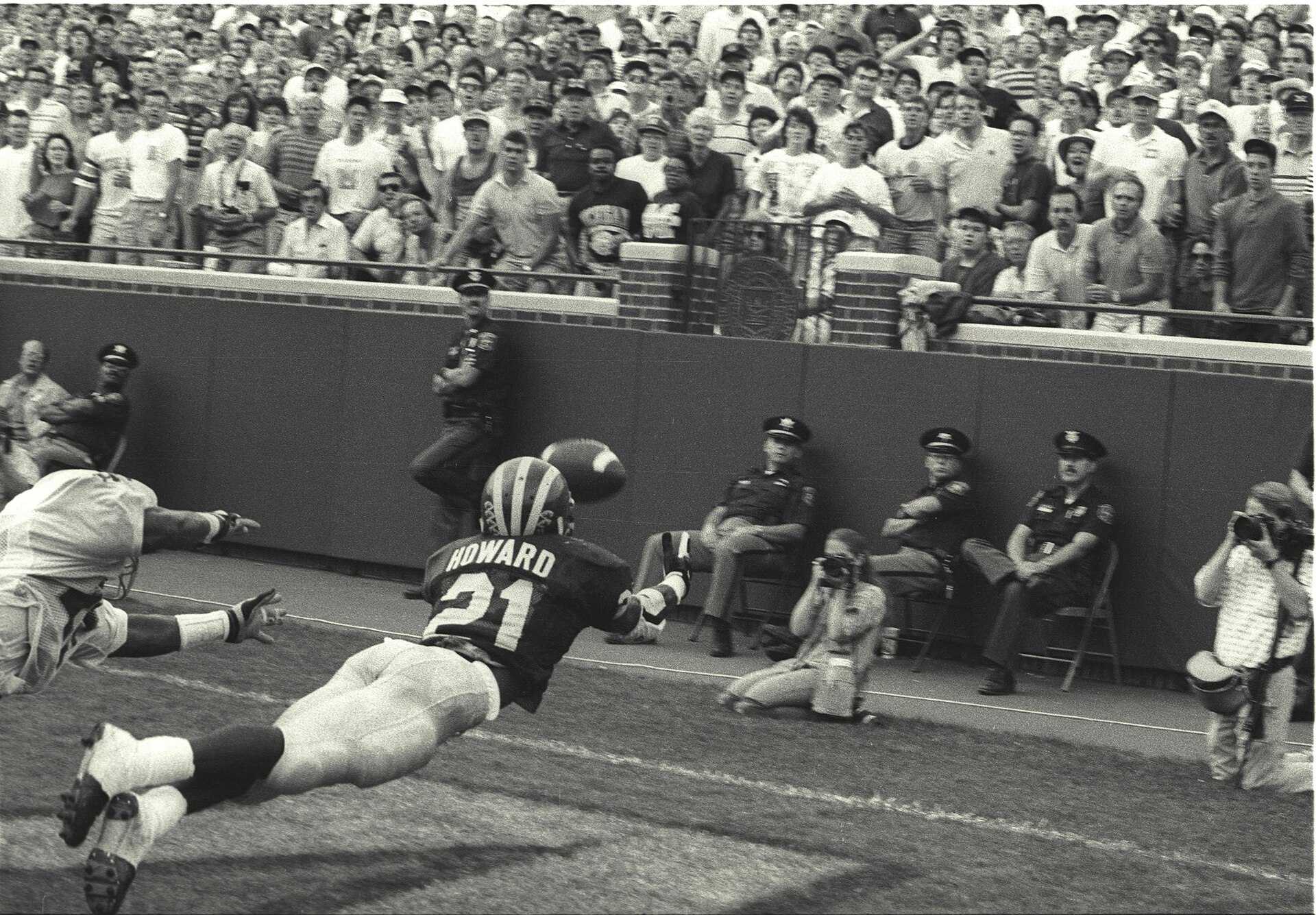 black and white game action photo of Desmond Howard “the Catch” vs Notre Dame, 1991.