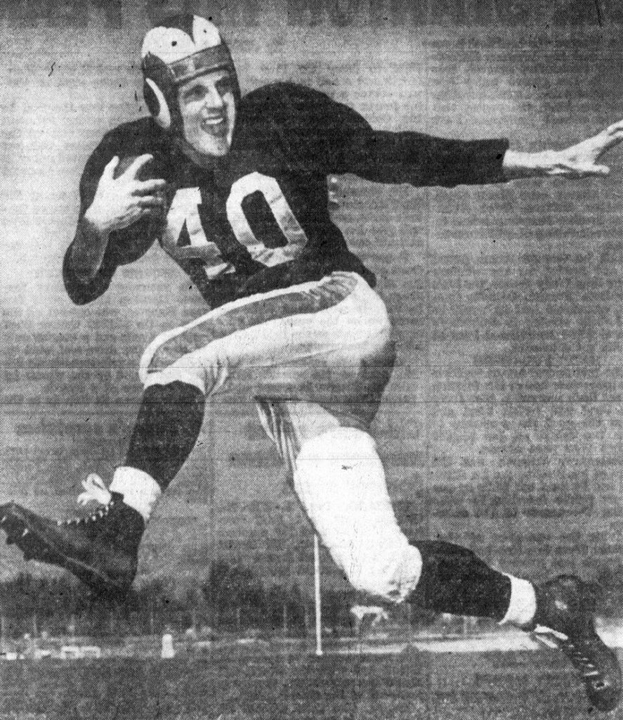 Black and white publicity pose of Elroy_Hirsch_1949 in LA Rams uniform in a football action pose.