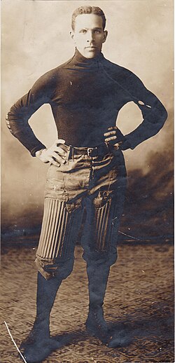 Black and white publicity shot of James E. Johnson in his Carlisle football uniform, circa 1903 in full uniform