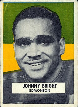 Semi color back ground with a black and white publicty head shot of Johnny Bright depicted on a football card.