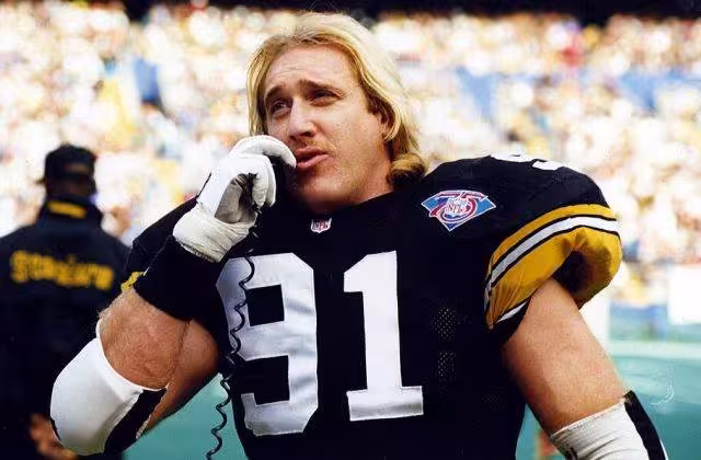 Color game day image of Kevin Greene talks to the Pittsburgh Steelers defensive coordinator during a game against the Miami Dolphins at Three Rivers Stadium on November 20th, 1994.