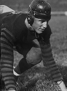 Vintage black and white game action Image of Dan McMillan on the FootballFoundation.org page,. Fair Use.