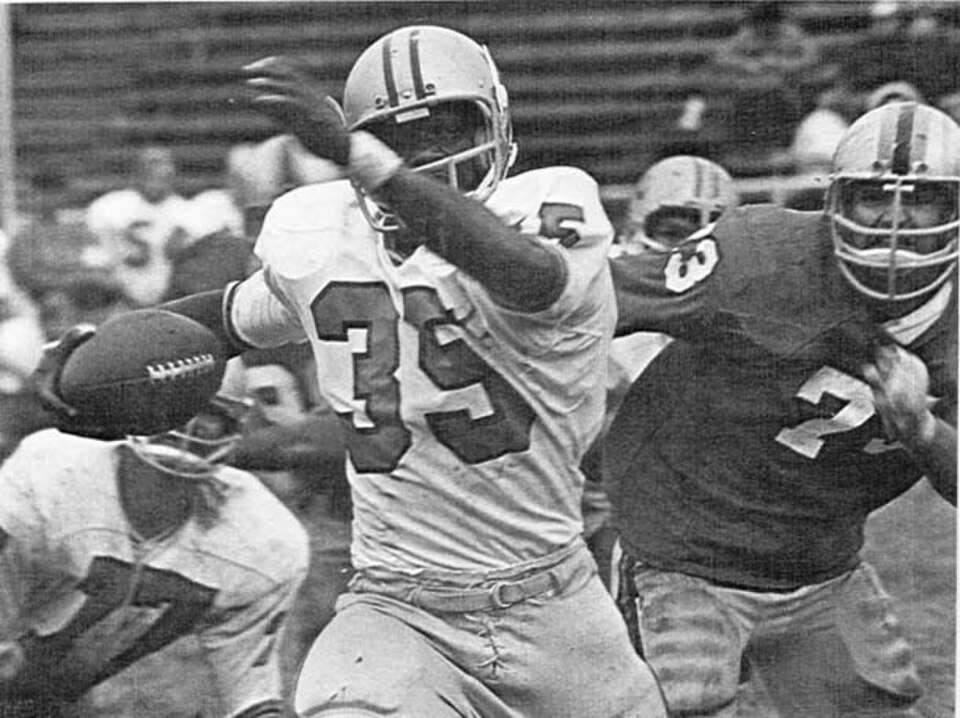 Black and white game action photo of Pacfic's runner wearing number 35 avoiding tackles in a 1971 game action shot.