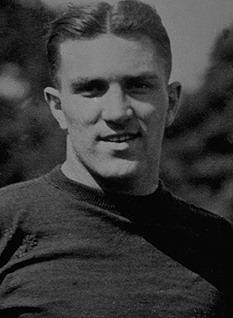 Vintage cropped black and white head shot image of Walter Koppisch playing for Columbia University in 1923 in football gear.