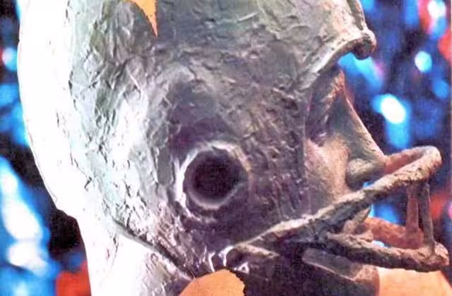 Color image of a bronze football player head, for Dickinson vs Muhlenburg - 21 Oct - Football Program