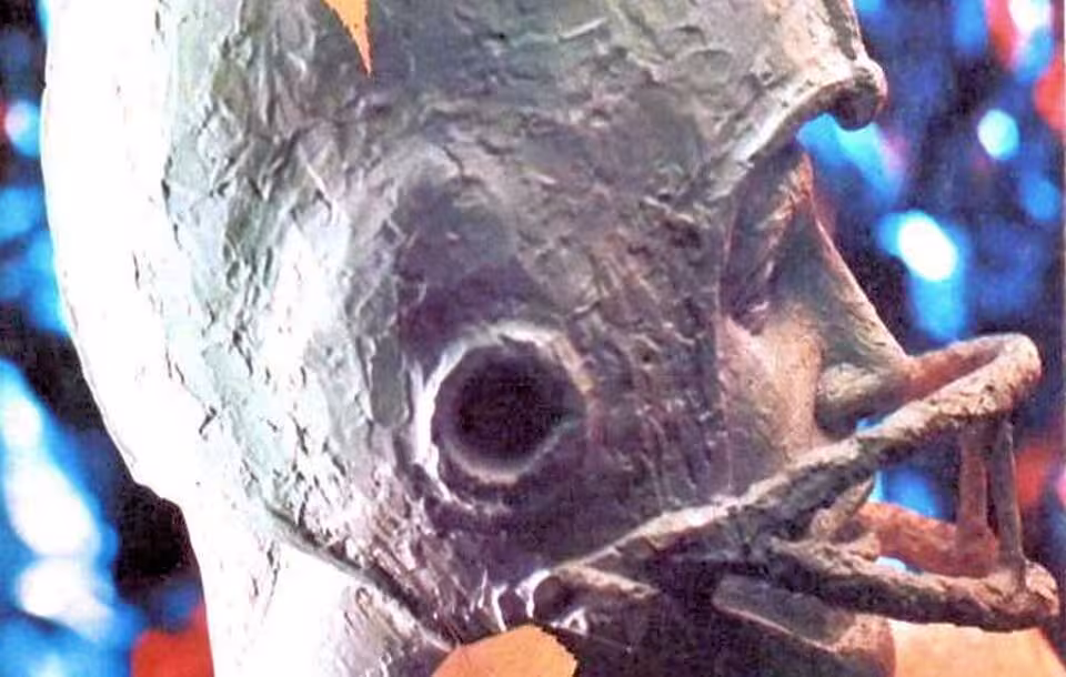 Color image of a bronze football player head, for Dickinson vs Muhlenburg - 21 Oct - Football Program