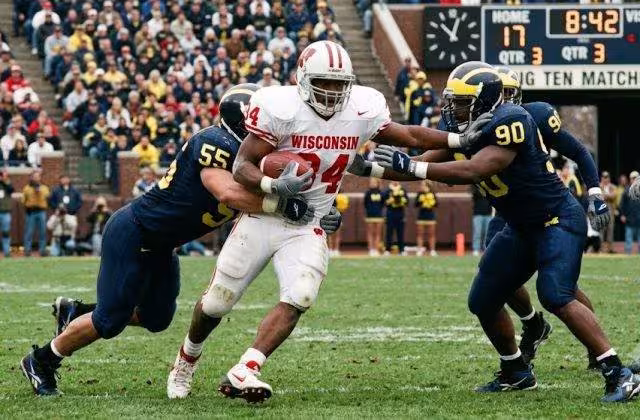 AI-created image of college football action in 1996 having any player gear shown being period correct and verified