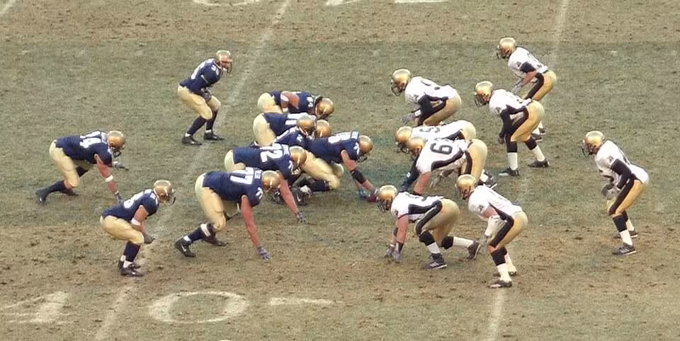American Football, play from scrimmage, isometric press and muscular preload.jpg Both the offense and defense crouch prior to beginning the play. This crouching action is a form of isometric press which preloads the muscles. This will enable the players to drive forward more powerfully when the snap is made and they engage the opposing team. This is a cropped version of a public domain photo. The original is listed on Wikimedia Commons as: File:Football play from scrimmage.jpg RickyBennison