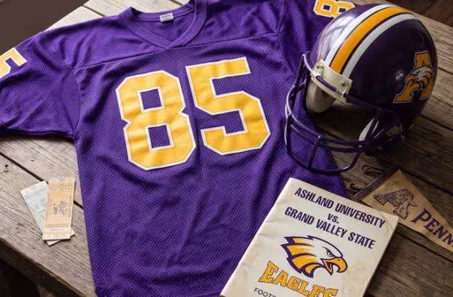 AI-generated purple jersey 85 on a wooden table with a helmet and period example of a program