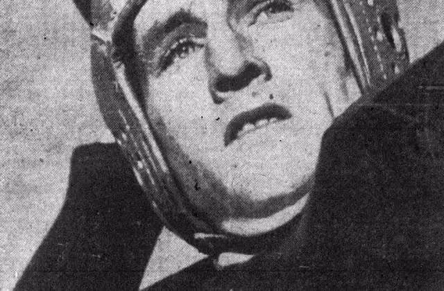 Black andwhite photo of American football player Bob Waterfield throwing.