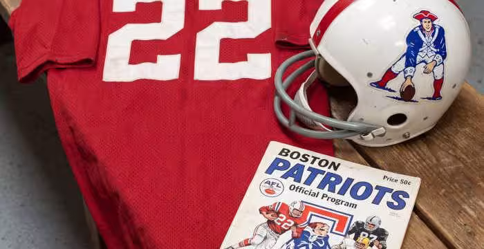 Gemini AI generated image of a 1960s-era red American football jersey 22, without a name on it, and a matching period-correct helmet, the program cover appropriate to the era and team.