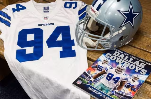 Gemini AI generated image of a 2010s-era white American football jersey 94, without a name on it, and a matching period-correct helmet, the program cover appropriate to the era and team.