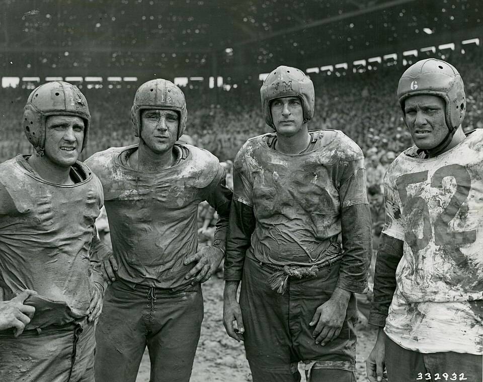 Four of Navy's Mudstained Stars Pose After the Army and Navy Football Game on the Fourth of July at Rizal Stadium, Manila, Philippines - NARA - 45697721.jpg Scope and content: Original Caption: Four of Navy's mudstained stars pose after the Army and Navy football game on the Fourth of July at Rizal Stadium, Manila, P.I. Left to Right: Geyer, Bloomfield, New Jersey; Hall, Chicago, Illinois; Horjes, Tacoma, Washington; Youngberg, Woodstock, Illinois.