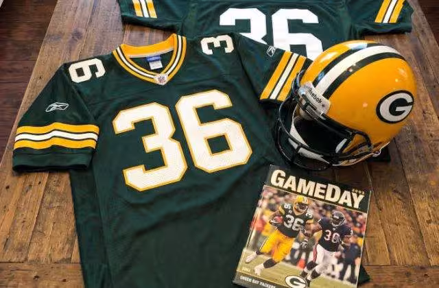 AI-generated green jersey 36 on a wooden table with a leather helmet and period example of a program