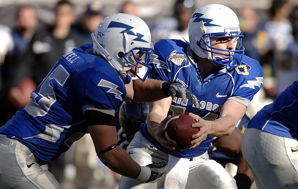 Full color game action image of U.S. Air Force Academy junior quarterback Shea Smith hands off to junior fullback Todd Newell during the Bell Helicopter Armed Forces Bowl at Amon G. Carter Stadium in Fort Worth, Texas, Dec. 31, 2007. The academy lost 42-36 against the California Golden Bears in their first bowl appearance since 2002 before a bowl record 40,905 fans and a national television audience on ESPN. ID: 071231-F-0558K-017 via Mike Kaplan