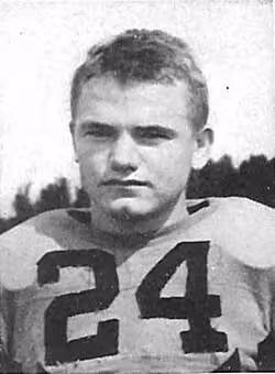 Publicty head shot on black and white of Nile Kinnick 1939 in Iowa uniform with helmet off