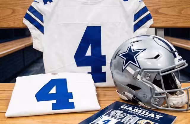 Gemini AI generated image of a 2020s-era white American football jersey 4, without a name on it, and a matching period-correct helmet, the program cover appropriate to the era and team.