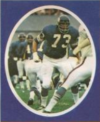 Purple background with an oval centered image of Yary in his purple Vikings number 73 jersey making a play.