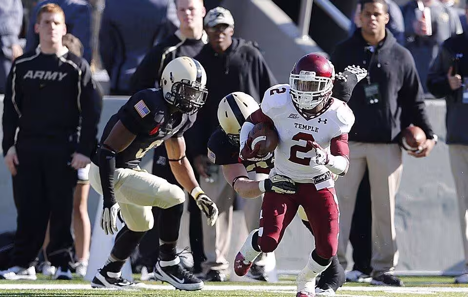Full color game action photo of Temple Owls running back Matt Brown (2) breaks away from from a Army Black Knights defender during the NCAA Division 1football game between Temple Owls and the Army Black Knight, Nov. 17, at Michie Stadium, West Point, New York.