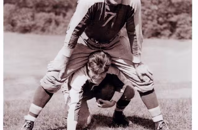 Vintage black and white image of Mel Hein (Number 7) over top Willis Smith at the New York Giant preseason camp in 1935. Courtesy of Larry Schmitt's collection.