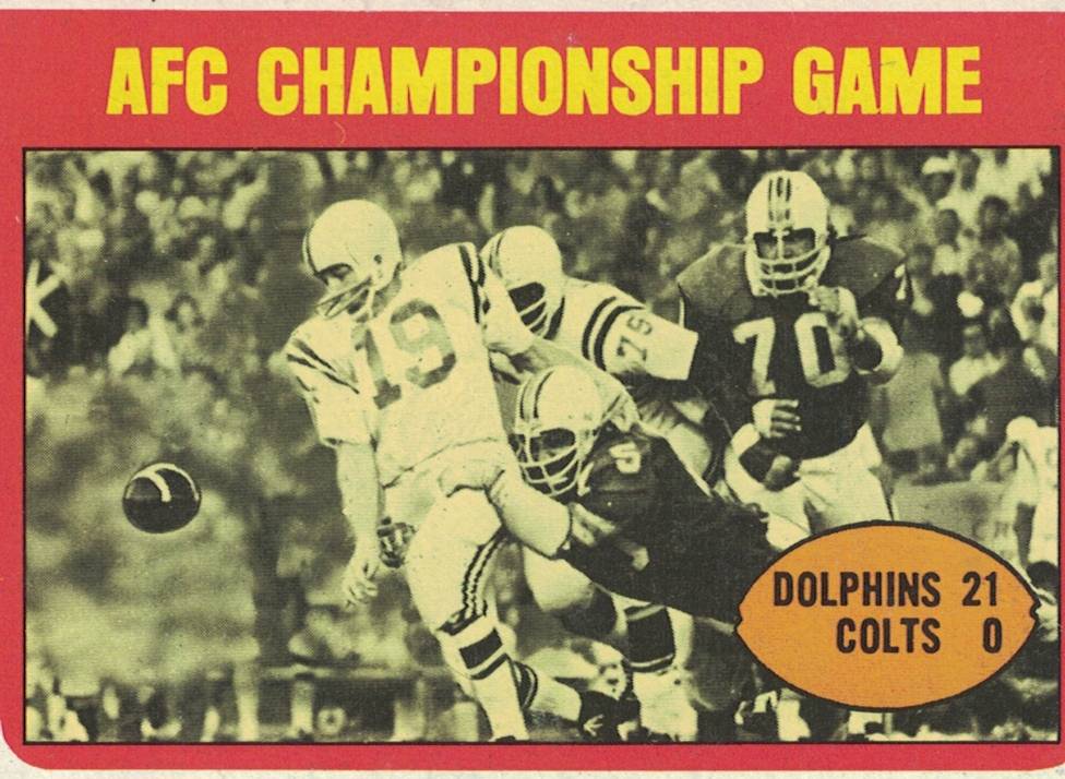 Semi-color trading card 1971 AFC Championship game played on January 2, 1972 shows Miami defensive lineman Manny Fernandez (Number 75) stripping Balt QB Johnny Unitas (Number 19). T.C.G. 1972 Card#137. Darin Hayes' personal collection.