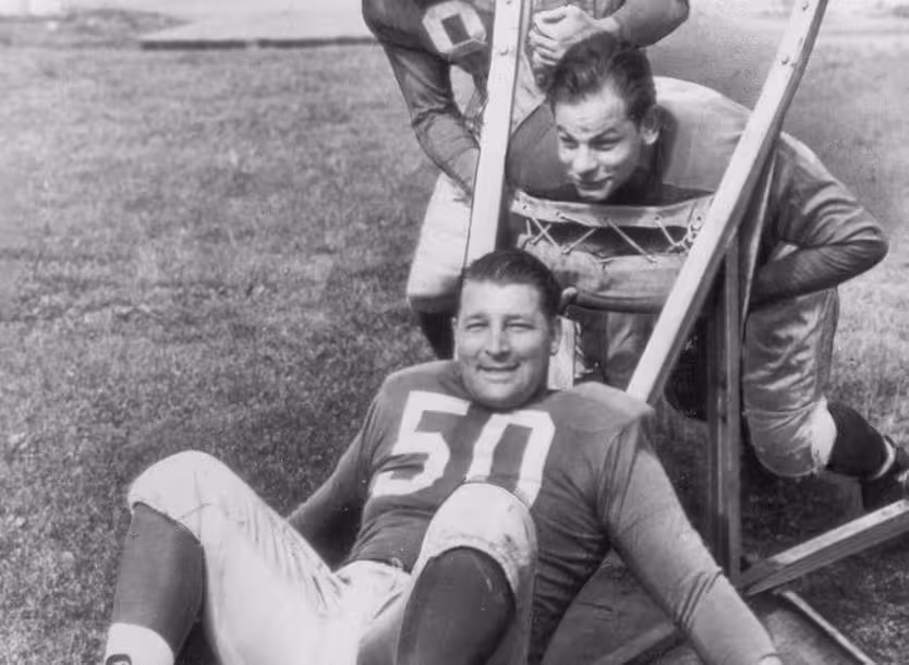 black and white photo of Alex Wojciechowicz (50), Emil Uremovich, Frank Szymanski 1946 at Lions practice.
