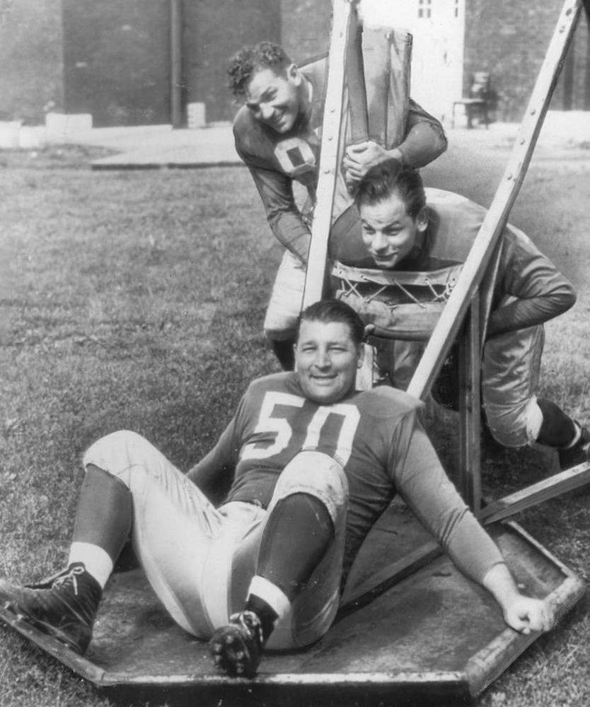 black and white photo of Alex Wojciechowicz (50), Emil Uremovich, Frank Szymanski 1946 at Lions practice.