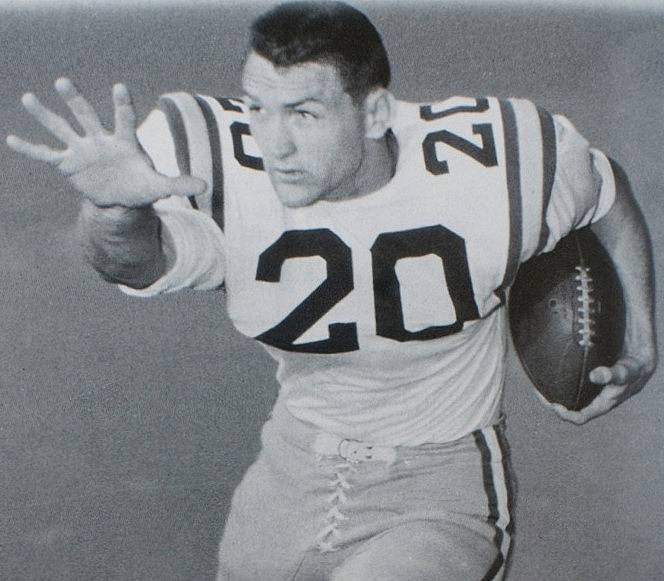Black and white publicity photo of This image is a photo of Billy Cannon that was originally released in a press packet by Louisiana State University (LSU) to promote their football team. It is used in a Wikipedia article about him to demonstrate how he looked while playing football for LSU.