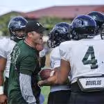 Chris Wiesehan, left, an assistant coach for the University of Hawaii football team, runs a drill during a practice at Joint Base Pearl Harbor-Hickam Aug. 15, 2013, in Hawaii. The practice took place on Earhart Field which overlooks the Hickam Field flight line where active military jets and commercial aircraft constantly take off and land. MCSN Johans Chavarro