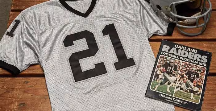 Gemini AI generated image of a 1970s-era white American football jersey 21, without a name on it, and a matching period-correct helmet, the program cover appropriate to the era and team.