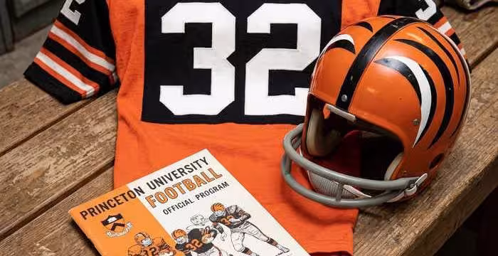 image of a 1965-era Princeton University American football jersey 32, without a name on it, and a matching period-correct helmet, the program cover appropriate to the era and team.