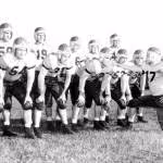 Black and white posed team huddle of Florida State University football squad: Tallahassee, Florida Date: 1947
