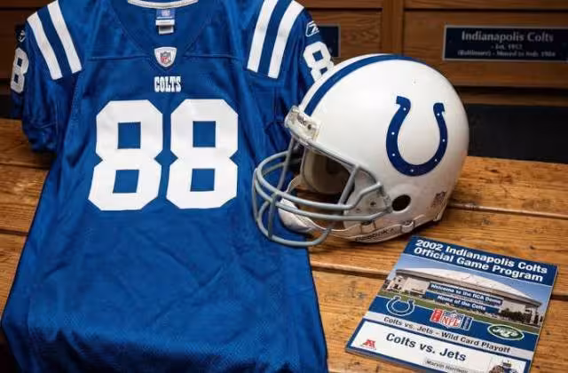 Gemini AI-created image of a 2002-era Indianaplois NFL American football jersey 88, without a name on it, and a matching period-correct helmet, the program cover appropriate to the era and team.