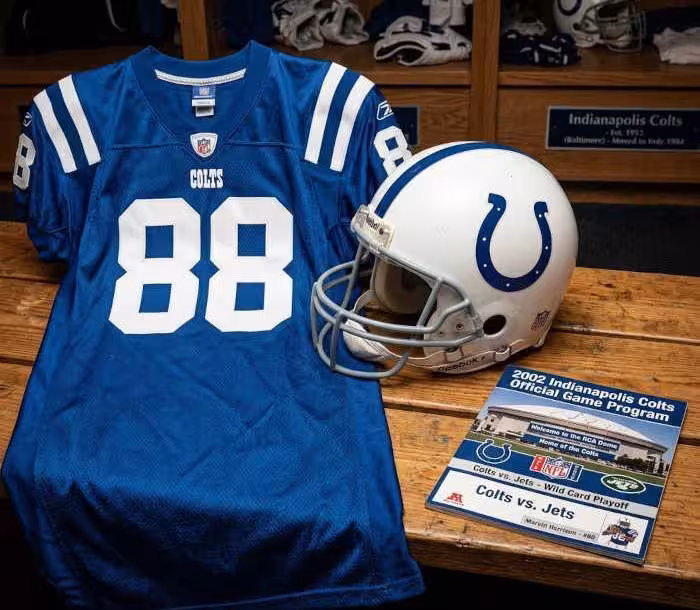 Gemini AI-created image of a 2002-era Indianaplois NFL American football jersey 88, without a name on it, and a matching period-correct helmet, the program cover appropriate to the era and team.