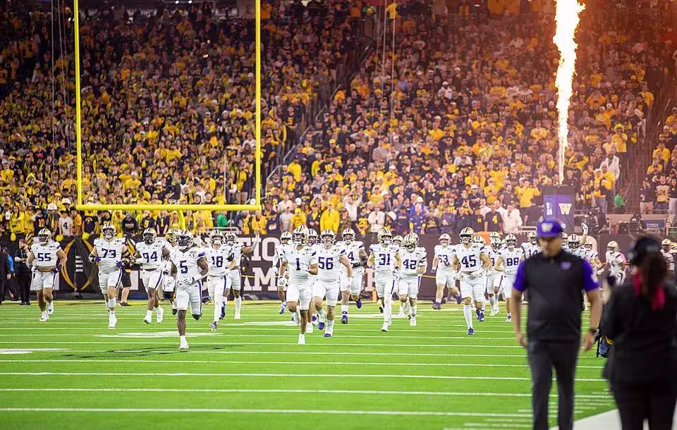 The Joint Armed Forces Color Guard, along with Soldiers from the United States Army Band, present the colors before the 2024 College Football Playoff National Championship Game between the University of Michigan Wolverines and the University of Washington Huskies on January 7-8, 2024 at NRG Stadium in Houston, TX. (U.S. Army photo by Sgt. Ethan Scofield)