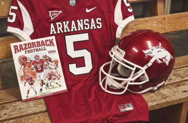 Gemini AI-created image of a 2006-era Arkansas American football jersey 5, without a name on it, and a matching period-correct helmet, the program cover appropriate to the era and team.