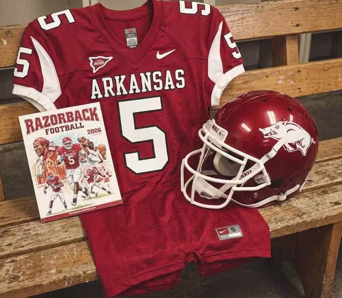 Gemini AI-created image of a 2006-era Arkansas American football jersey 5, without a name on it, and a matching period-correct helmet, the program cover appropriate to the era and team.