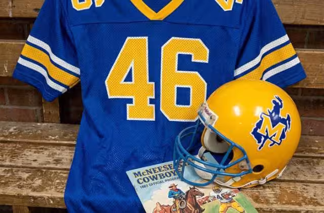 Gemini AI-created image of a 1982-era McNeese State American football jersey 46, without a name on it, and a matching period-correct helmet, the program cover appropriate to the era and team.