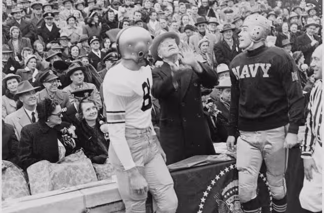 Photograph of President Truman tossing a coin in the air before the annual Army-Navy football game in Philadelphia, December 2, 1950