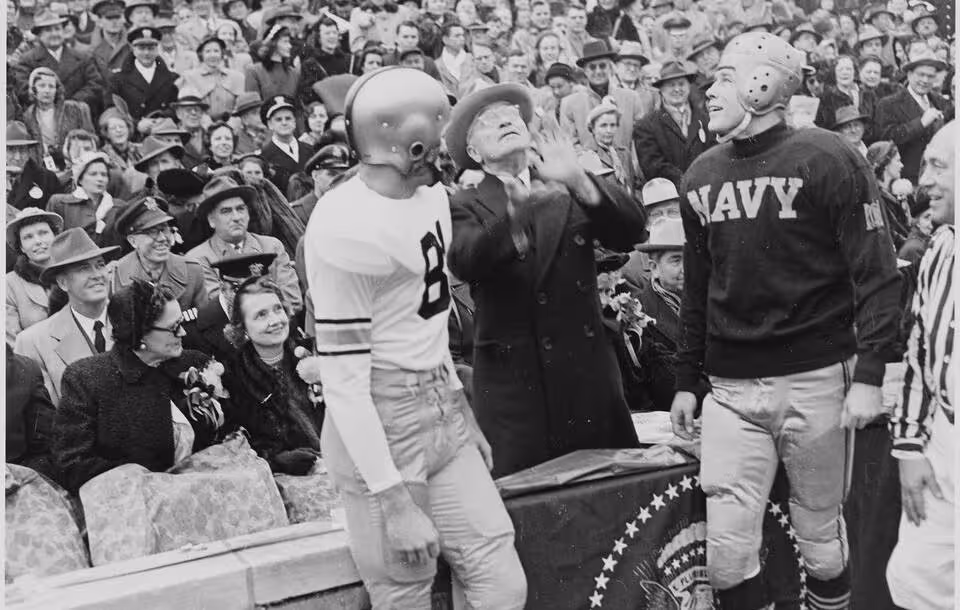 Photograph of President Truman tossing a coin in the air before the annual Army-Navy football game in Philadelphia, December 2, 1950