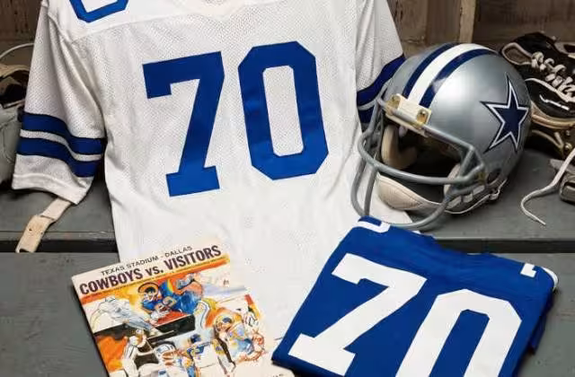 Gemini AI created image of a 1973-era Dallas NFL American football jersey 70, without a name on it, and a matching period-correct helmet, the program cover appropriate to the era and team.