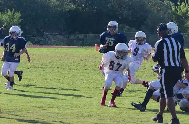 Color game day image, No doubt a proud father at a youth game on September 26, 2018, taking this snap shot called Will playing football 092618 uploaded to Wikimedia Commons by John Champion.