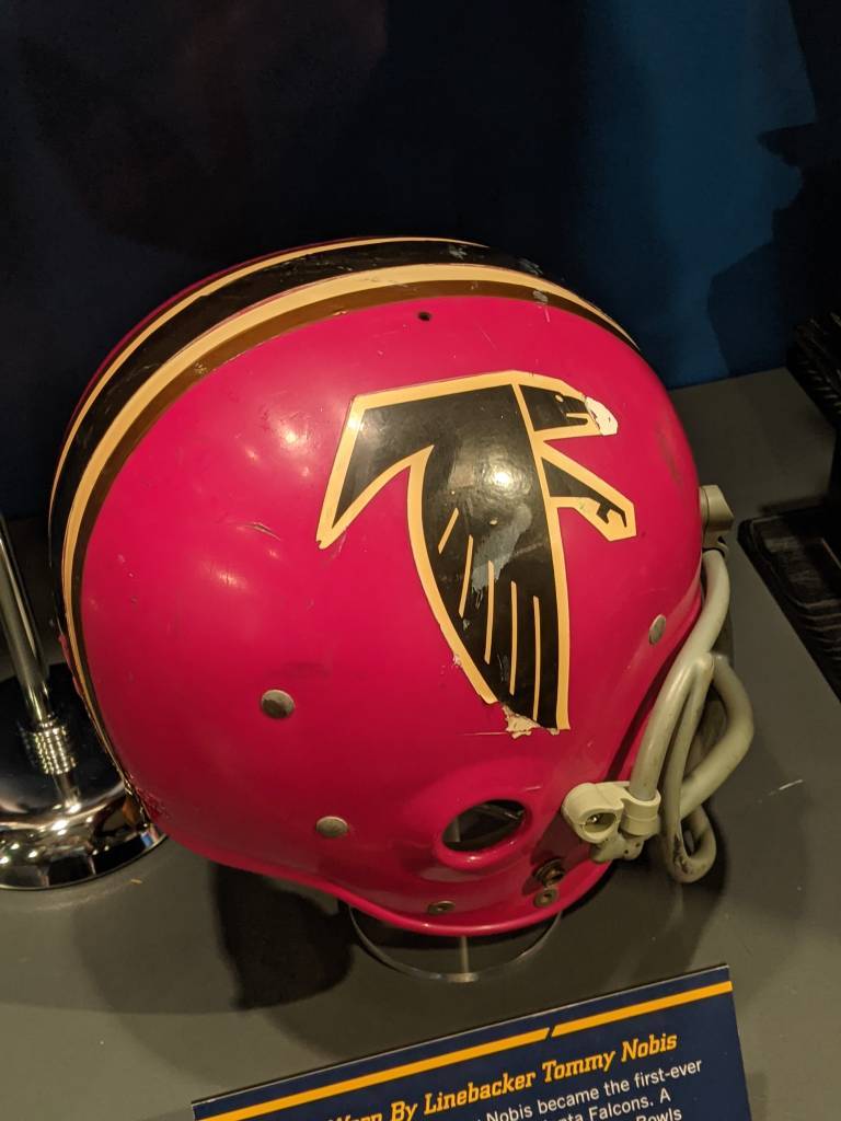 Full color image of Tommy Nobis red Atlanta Falcons helmet on display at the Pro Football Hall of Fame in 2021, Pic taken by Darin Hayes.