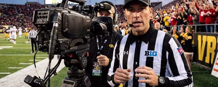 Gemini AI-created image of Big Ten Ref talking to TV camera.