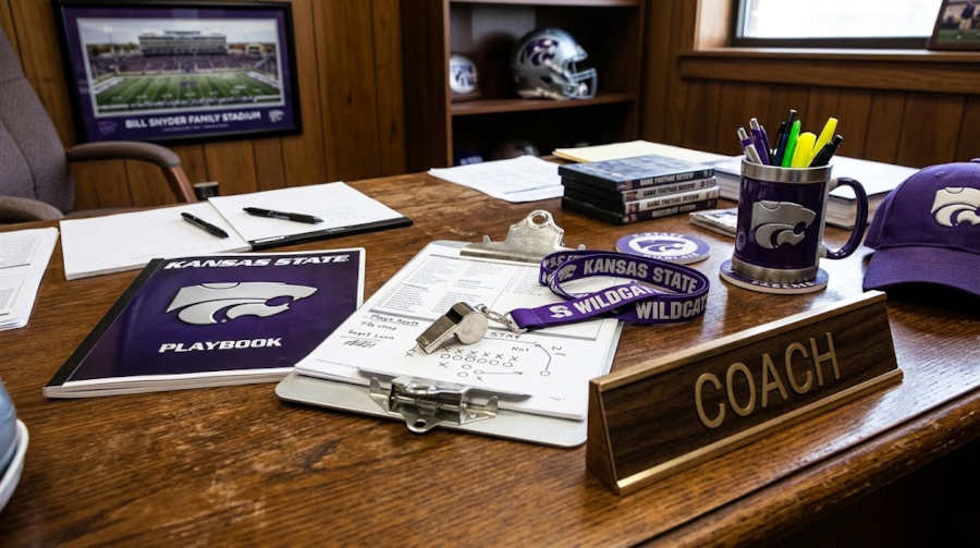 Gemini AI-created image of a wooden desk on an American college football coaches office with a placard that says "Coach" a clipboard, a playbook, a whistle and lanyard, and some purple items that refer to Kansas State football.